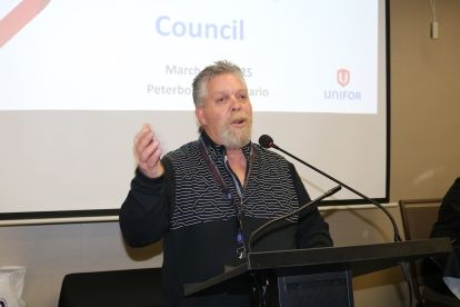 A man speaks at a podium