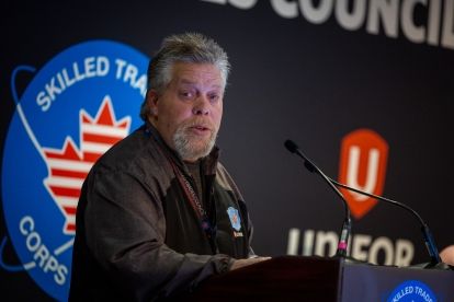 A man speaks at a podium