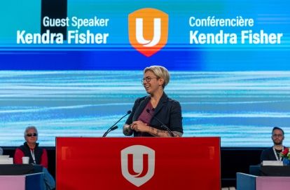 Kendra Fisher speaking at Unifor podium