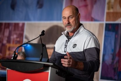 Len Poirier speaking at the podium