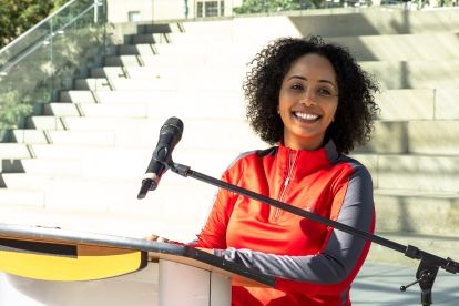 A woman smiling at a podium
