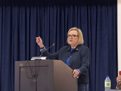 A women speaks at a podium