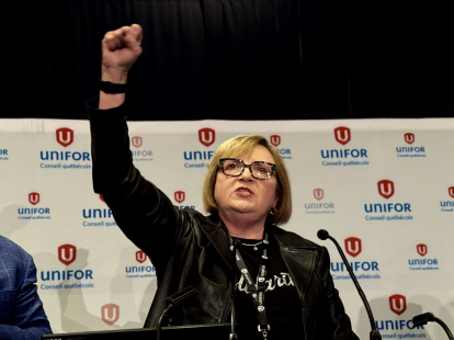 A woman standing with her fist in the air