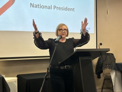 Lana Payne speaks at a podium