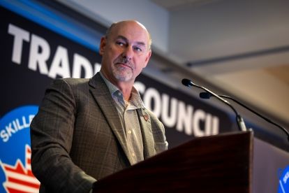 A man speaks at a podium