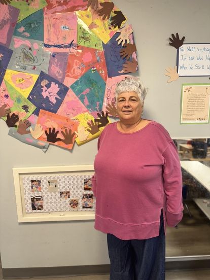 a women standing smiling at the camera