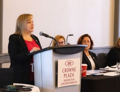 A women speaks at a podium