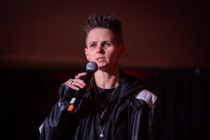 A women speaking into a mic