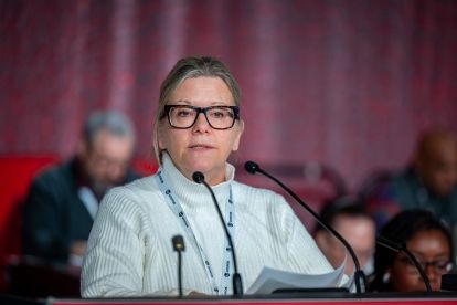 A women speaks at a podium