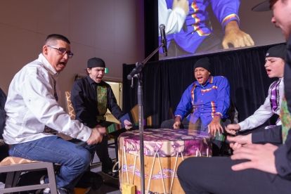 Four young men drumming