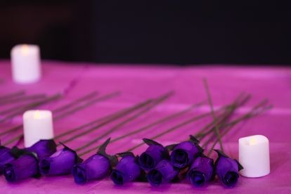 purple flowers laying on a table with candles