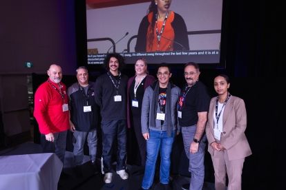 Seven people posing side stage at ORC.