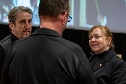 Three people talking in a huddle