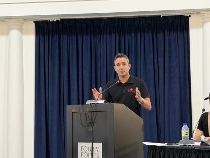 A man speaks at a podium