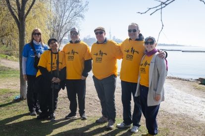 seven people pose outside on a sunny spring day