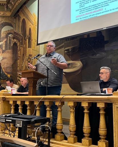 Unifor Local 444 President David Cassidy speaking at a podium during a ratification meeting