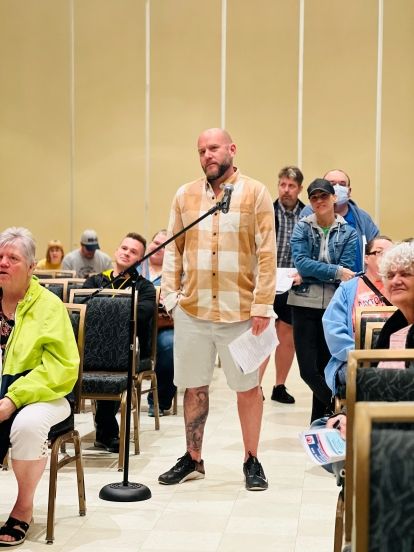 Unifor Local 444 member standing at a microphone during a ratification meeting