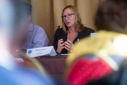 a women speaking at a mic