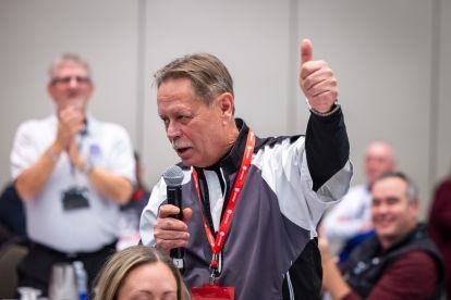 a man speaks into a mic