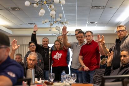 group of people standing at a floor microphone