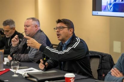 man seated in front of a microphone