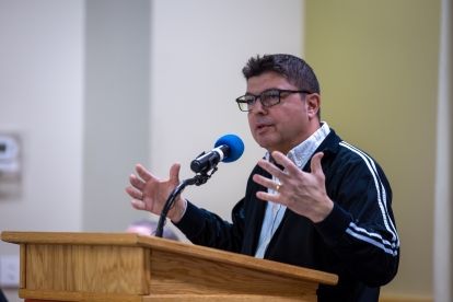 A man speaks at a podium