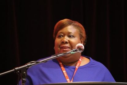 a women speaks at a mic