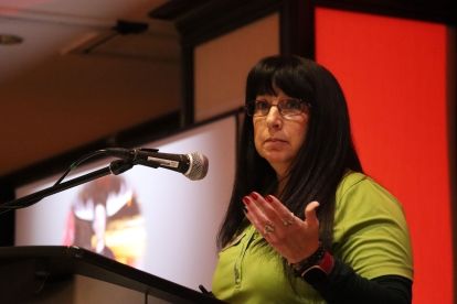 A women speaks at a podium