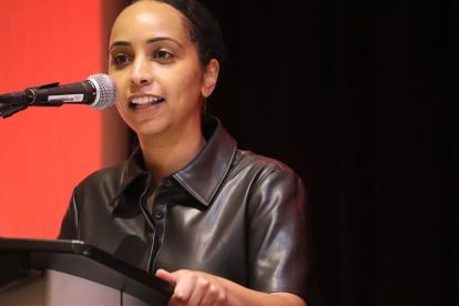 a women speaks at a mic