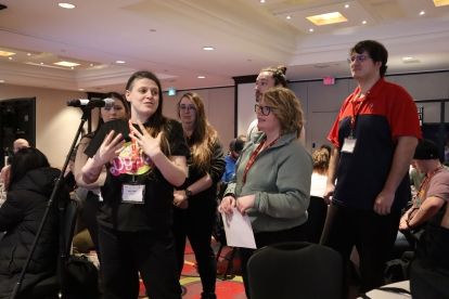 Three people at a mic