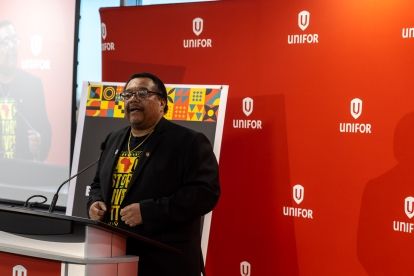 A man speaks at a podium mic