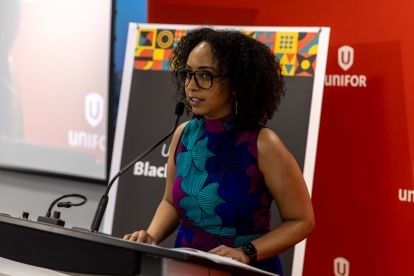 A women speaking at a podium mic