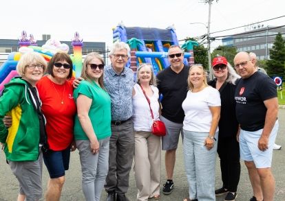A group of people standing in front of jumpy castles