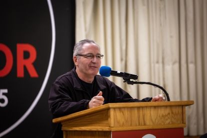 A man speaks at a podium