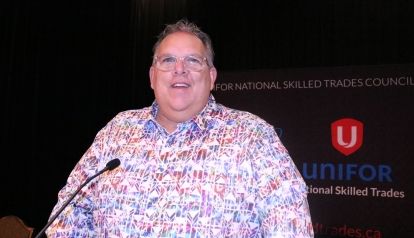 Man standing at podium with microphone
