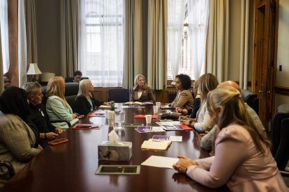 Women sitting around a boardroom table.