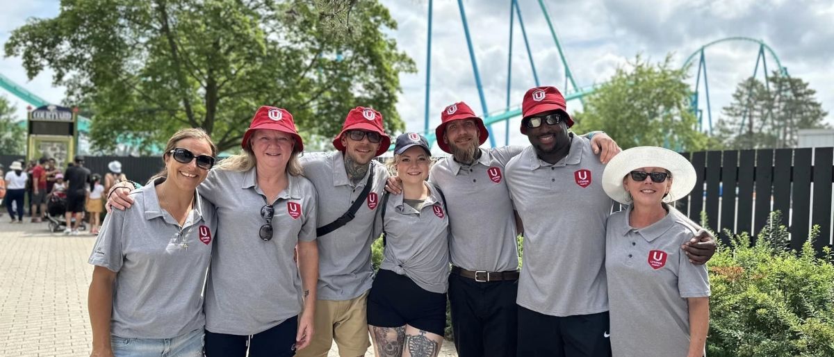 A family of six posing in matching gray t-shirts at Canada's Wonderland