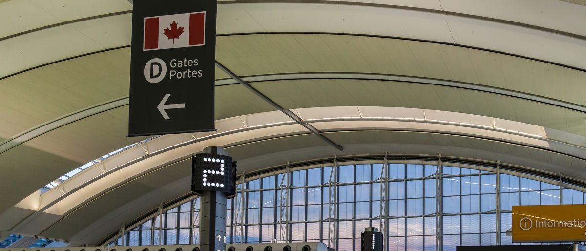 inside a airport terminal sign for gate D