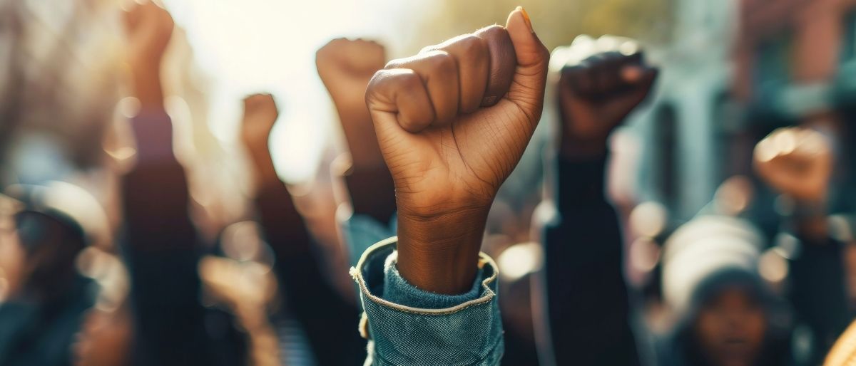 A black fist in the air with African banner art