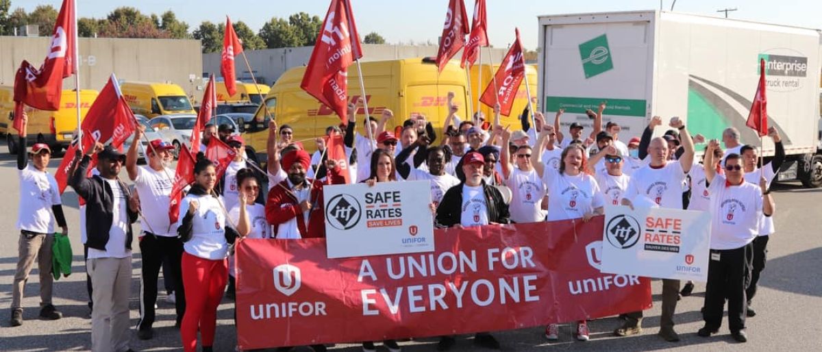 A large group standing in front of a banner