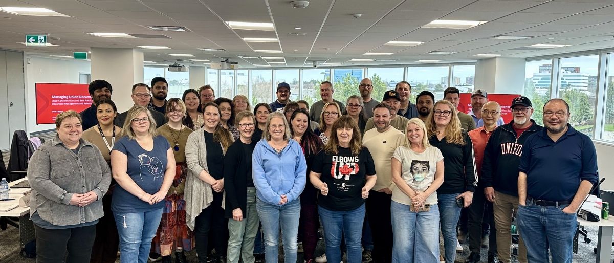 Group of people under overhead lights.