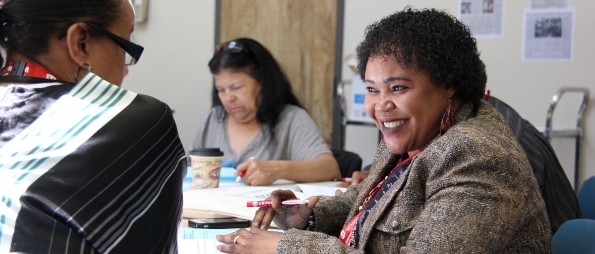 black women talking at a table 