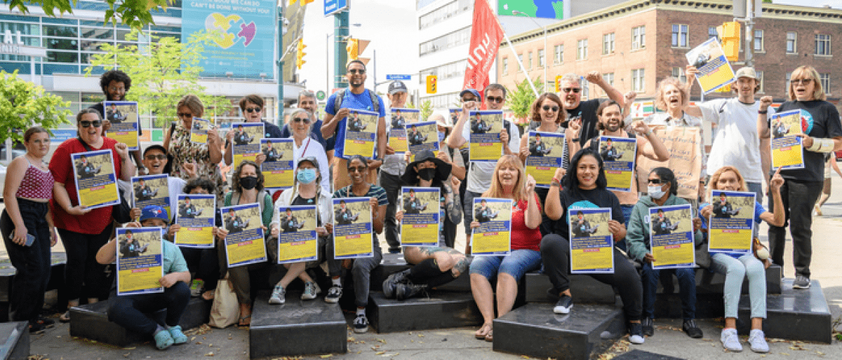 A group of people holding Fix EI signs 