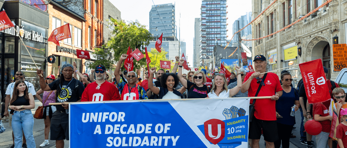 A group of people carrying a banner on a Toronto street.