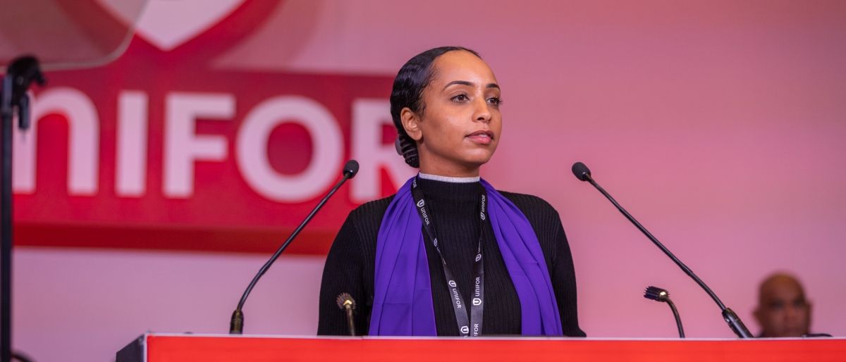A women speaking at a podium.