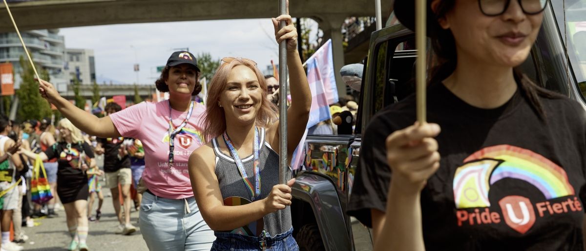 Three women walking in a parade 