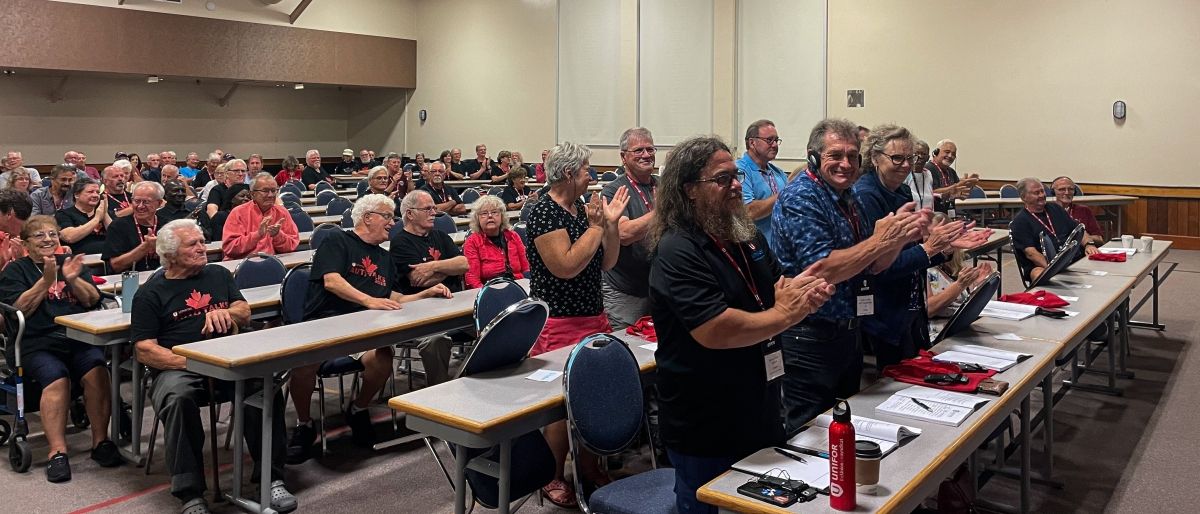 People giving a standing ovation at a conference.