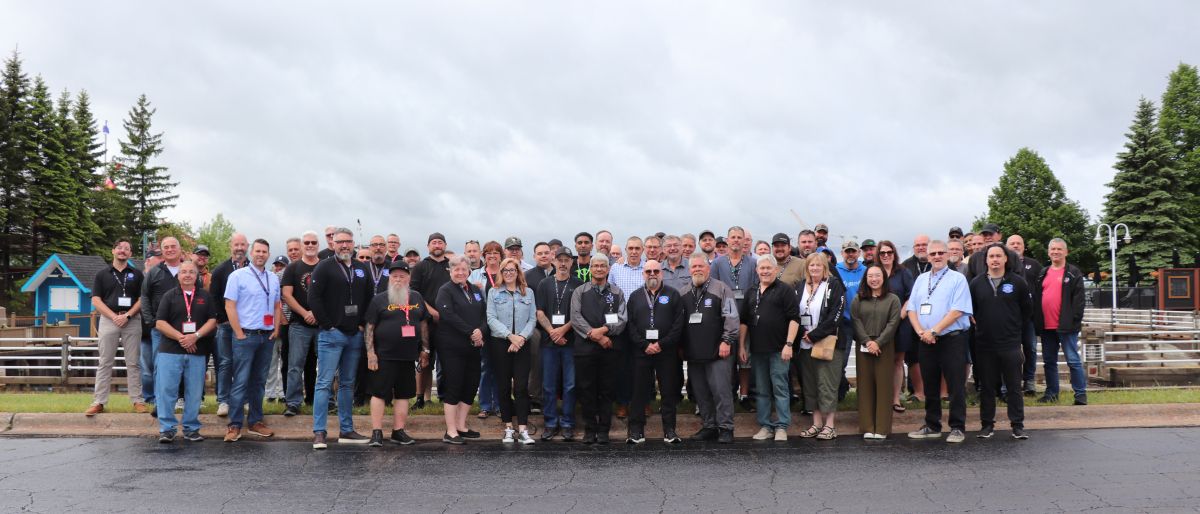 A large group photo outside on a cloudy day.