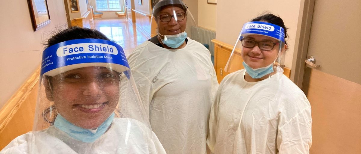 Frontline health care workers in full PPE.