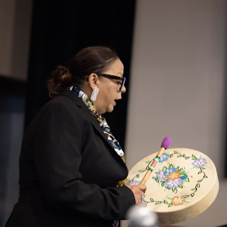 A women banging on a drum